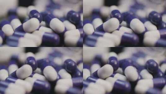 紫色和白色的药胶囊躺在一堆高清在线视频素材下载