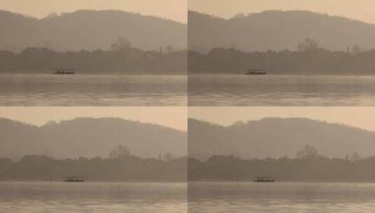 杭州西湖湖面游船手划船晨曦空镜高清在线视频素材下载