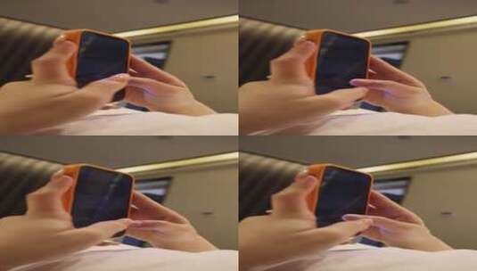 人像生活：美女躺在卧室床上玩着手机高清在线视频素材下载