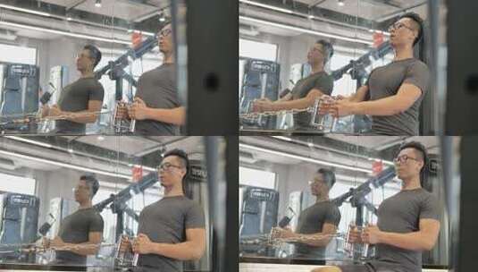 男子在健身房使用划船器锻炼背部肌肉高清在线视频素材下载