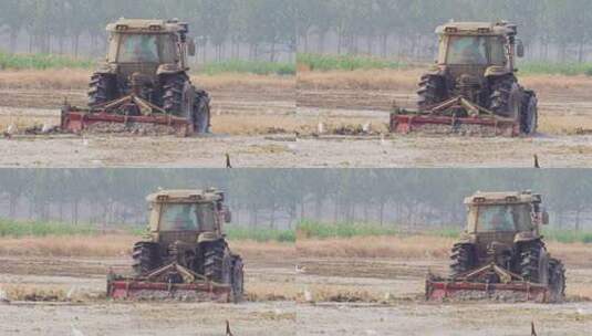 航拍拖拉机耕作土地高清在线视频素材下载