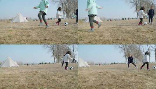 冬季在公园草坪上踢球的三个女孩高清在线视频素材下载