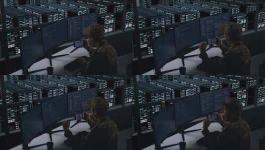 快乐的亚洲军人在数据中心编写代码时看着手高清在线视频素材下载