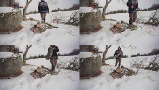 男人在雪地里堆积切割的原木。-特写镜头高清在线视频素材下载