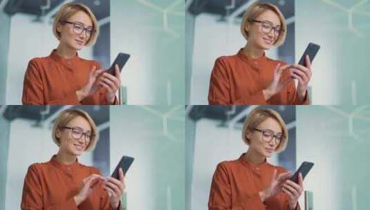 一个戴着眼镜的快乐年轻金发女子在现代办公高清在线视频素材下载