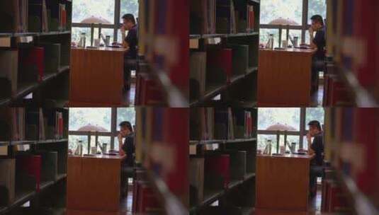 一名男子在图书馆看书用心高清在线视频素材下载