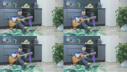 男人在客厅弹吉他高清在线视频素材下载