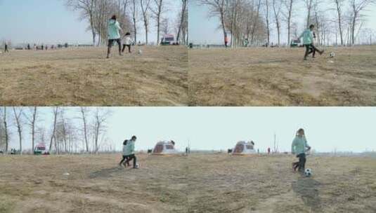 冬季在公园草坪上踢球的两个女孩高清在线视频素材下载