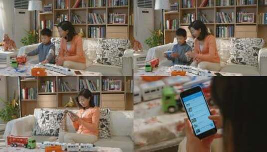 年轻妈妈使用手机陪儿子玩耍高清在线视频素材下载