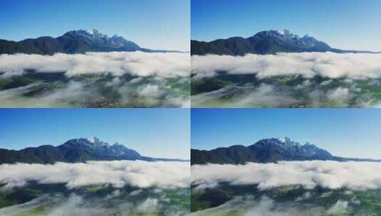 清晨云雾中的玉龙雪山和绿色村庄高清在线视频素材下载
