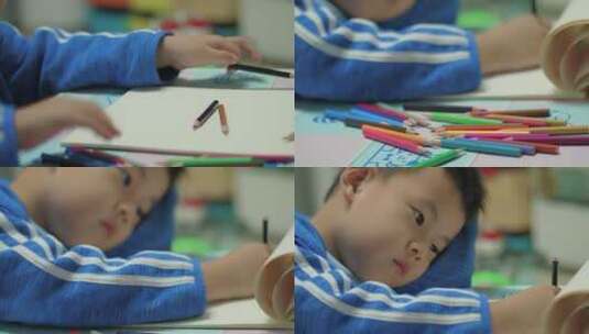 孩子拿着彩色铅笔在白纸上画画高清在线视频素材下载