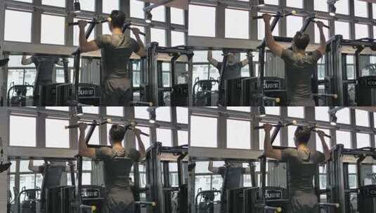 男子在健身房使用器械锻炼引体向上高清在线视频素材下载