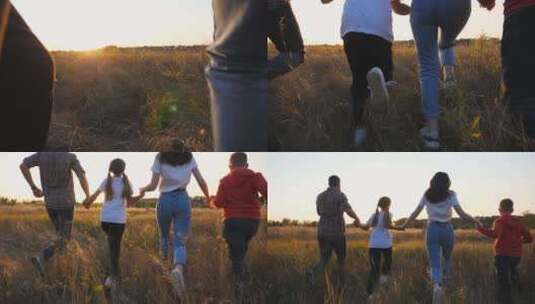 日落时分，快乐的父母带着孩子在草地上慢跑，手牵着手高清在线视频素材下载