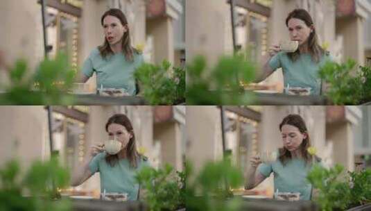 一位中年妇女在户外咖啡馆喝咖啡，吃甜点，高清在线视频素材下载