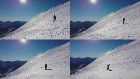 一个人在晴天爬上白雪皑皑的山高清在线视频素材下载