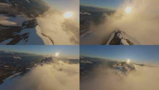FPV穿越机无人机航拍雪山山顶日出天际线云高清在线视频素材下载