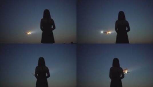 日落黄昏机场美女看向飞机降落高清在线视频素材下载