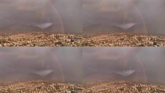 城市上空华丽的粉红色日落地平线上的雨和美丽的双彩虹鸟瞰高清在线视频素材下载