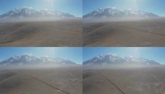 新疆正午沙地雪山航拍高清在线视频素材下载