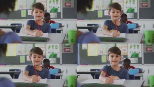男生坐在教室里做笔记高清在线视频素材下载