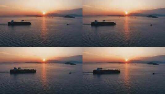 4K航拍货船出海集装箱轮船迎着日出驶出港口高清在线视频素材下载