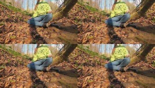 一个盘腿坐在森林里的女人高清在线视频素材下载