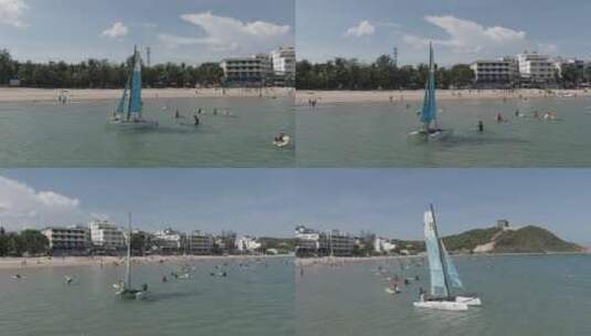 航拍海南三亚后海海滩冲浪游玩高清在线视频素材下载