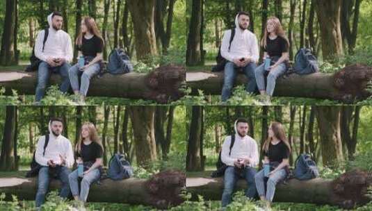 情侣坐在木头上聊天高清在线视频素材下载