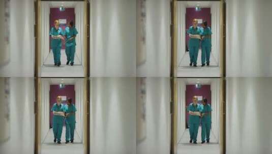 两个医务人员在医院走廊里行走高清在线视频素材下载