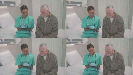 医生和一位老病人坐在病床边上高清在线视频素材下载
