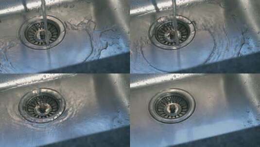 水龙头的水流掉入洗碗槽高清在线视频素材下载