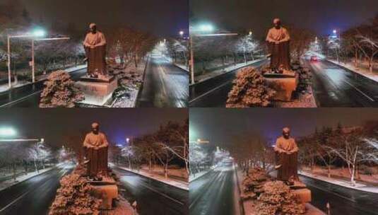 航拍鉴真路扬州雪景夜景鉴真像飘雪高清在线视频素材下载