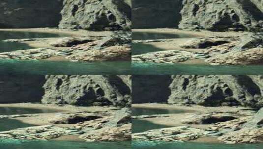 靠近岩石悬崖的小沙滩海洋海滩高清在线视频素材下载