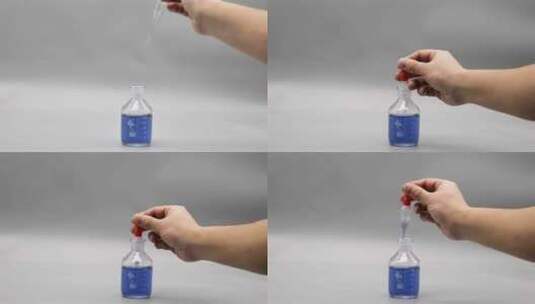 用滴管在滴瓶里吸取蓝色溶液高清在线视频素材下载