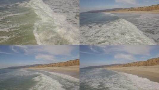 航拍下在拍打沙滩的海浪高清在线视频素材下载
