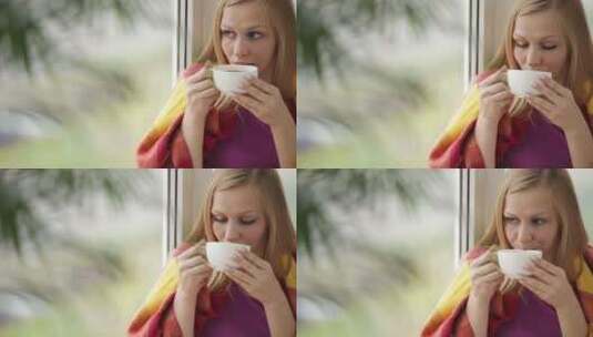 女孩坐在窗边喝茶高清在线视频素材下载