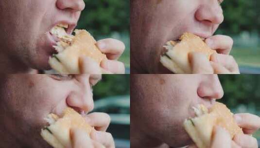 一个饥饿的男人急切地吃汉堡包高清在线视频素材下载