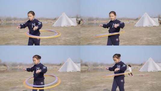 冬天在户外玩呼啦圈的中国女孩高清在线视频素材下载
