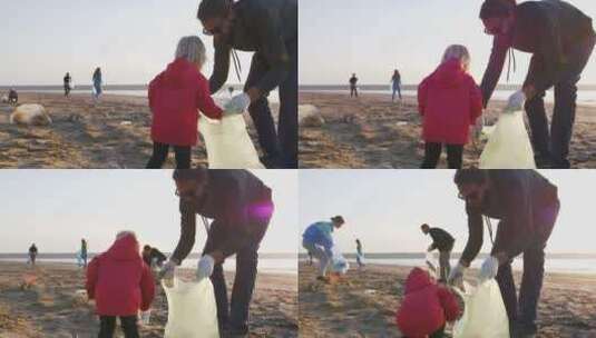 小女孩和爸爸在沙滩上捡垃圾高清在线视频素材下载