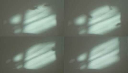 阳光穿过水族箱鱼缸鱼儿的影子映在白墙上高清在线视频素材下载