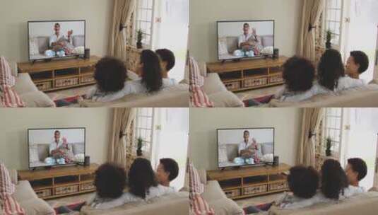 非裔美国家庭坐在家里的沙发上，在电视上进行视频通话高清在线视频素材下载