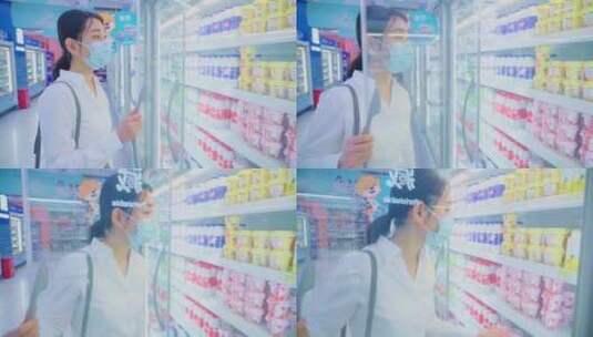 戴口罩的青年女人在超市挑选酸奶高清在线视频素材下载