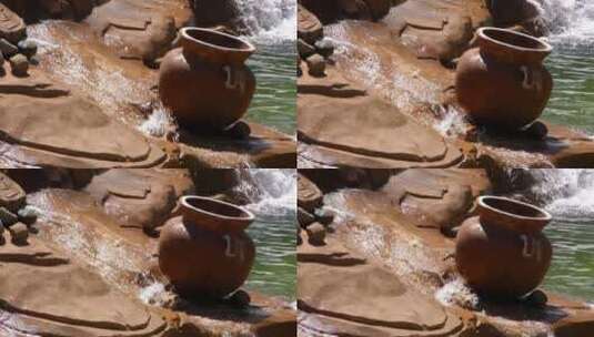 小岩石瀑布上的陶罐高清在线视频素材下载