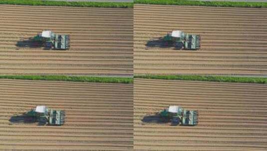 农用拖拉机在耕地上播种高清在线视频素材下载