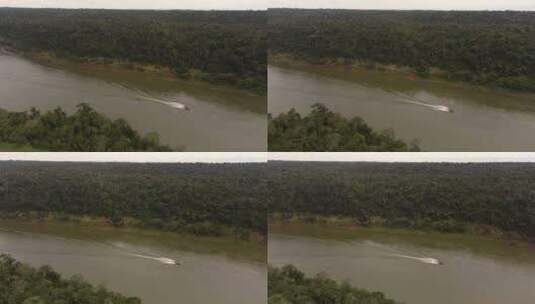 鸟瞰在亚马逊雨林亚马逊河上空巡航的摩托艇高清在线视频素材下载