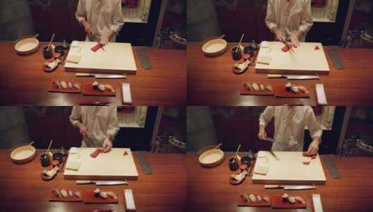 寿司、鱼和厨师双手的特写镜头，晚上在餐厅高清在线视频素材下载