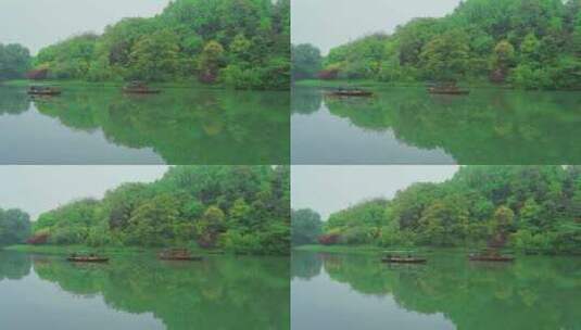 杭州西湖浴鹄湾春天湖面上的手划船高清在线视频素材下载