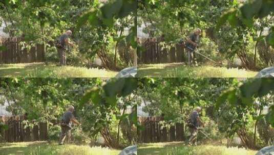 男人用割草机修剪后院杂草丛生的草。宽高清在线视频素材下载