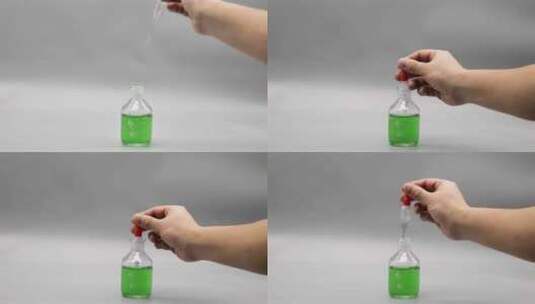 用滴管在滴瓶里吸取绿色溶液高清在线视频素材下载