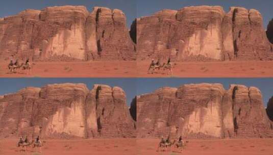 游客骑着骆驼穿过沙漠高清在线视频素材下载